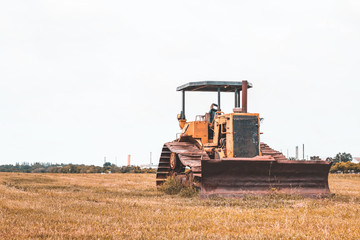 Old rusty tractor in field