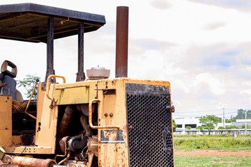 Old rusty tractor in field