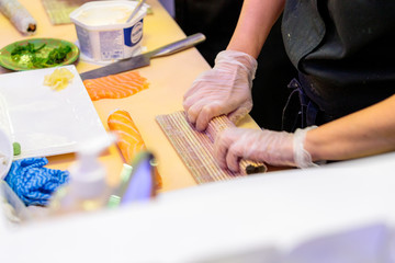 chef preparing sushi in restaurant