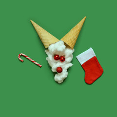 Santas reindeer made with Christmas bauble decoration and ice cream cones . Minimal flat lay Christmas concept.