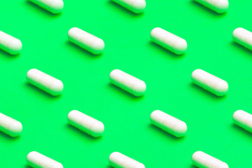 white pills on a green background