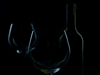  glass of red and pink wine on a black background. Wine list menu. Close up of the power of glasses and bottles in low key