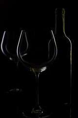  glass of red and pink wine on a black background. Wine list menu. Close up of the power of glasses and bottles in low key
