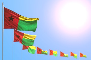 beautiful holiday flag 3d illustration. - many Guinea-Bissau flags placed diagonal with soft focus and free place for content