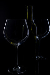  glass of red and pink wine on a black background. Wine list menu. Close up of the power of glasses and bottles in low key