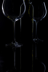  glass of red and pink wine on a black background. Wine list menu. Close up of the power of glasses and bottles in low key