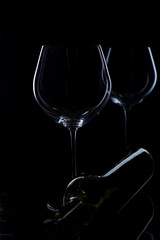  glass of red and pink wine on a black background. Wine list menu. Close up of the power of glasses and bottles in low key