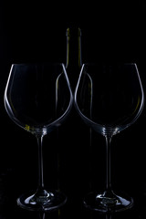  glass of red and pink wine on a black background. Wine list menu. Close up of the power of glasses and bottles in low key