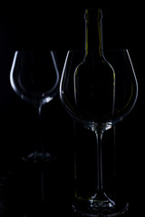  glass of red and pink wine on a black background. Wine list menu. Close up of the power of glasses and bottles in low key
