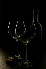  glass of red and pink wine on a black background. Wine list menu. Close up of the power of glasses and bottles in low key
