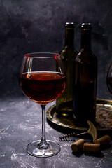 Red wine. Bottle and glass of red wine. Vintage style. Red wine on a black background. Design with space for your text.