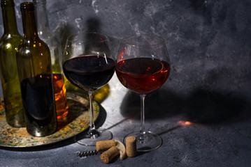 Red wine. Bottle and glass of red wine. Vintage style. Red wine on a black background. Design with space for your text.