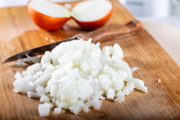 Chopped onions on wooden cutting board