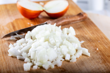 Chopped onions on wooden cutting board