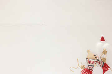 Creative Top View Flat Lay Christmas New Year Festive Winter Concept Eco Composition in Bottom Angle: Christmas Tree, Scarf, Hat, Snowballs, Gift Boxes. White Wooden Background, Copy Space, Banner.