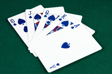 Poker cards on green background with copy space. Winning combination of cards