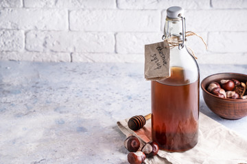 Homemade chestnut syrup in bottle Alternative food and drink Trend food 2020 Copy space.