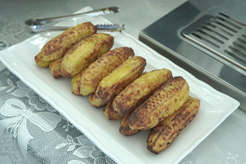 Grilled bananas placed on a white food tray Near the toaster