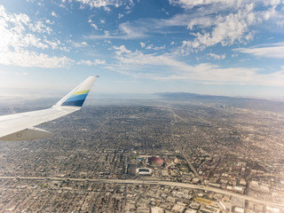 Wingtip in the foreground with landscapes in the background