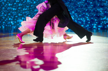 Woman in pink gown and man black tailcoat. Latino dancing