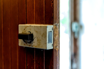 Opened vintage style door lock on natural wooden door