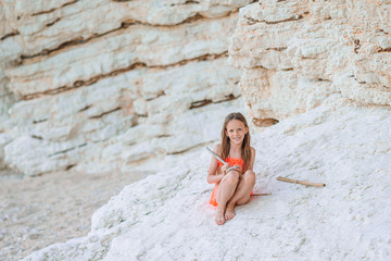 Cute little girl at beach during summer vacation