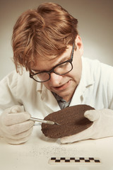 Scientist in museum office working on cuneiform find