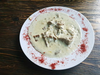 Stew in cream sauce on a wooden table.