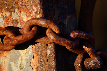 part of a rusty chain in sunlight 