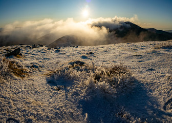 Snowy mountain top in Snowdonia National Park, Wales at sunset