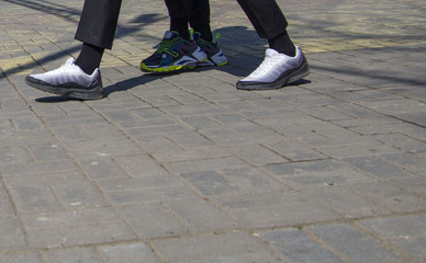 Obraz premium walking on city streets with shoes and athletic shoes