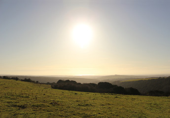 A view from Butser Hill towards the Isle of Wight, with the Solent shining on the horizon.