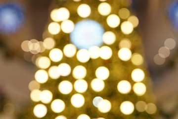 Fototapeta na wymiar The round yellow bokeh of the Christmas tree Use as lens blur background.