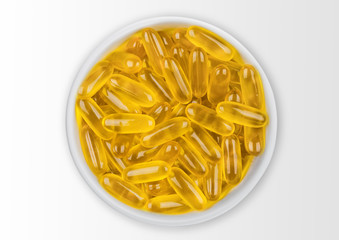 White bowl of raw natural organic linseed flax-seed oil omega 3 capsules on white background.