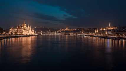 Fototapeta na wymiar Incredible Evening View of Budapest parliament and Danube river at sunset, Hungary. Wonderful Cityscape with Colorful sky.