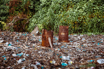 Dump and Washed Up Waste, Debries, Plastic Bottles & Bags, Iron Barrels on a Sandy Beach in Maldives. Blue Sky, Ocean, Paradise. Sunny Side of Life