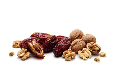 Dates and walnuts on white background.