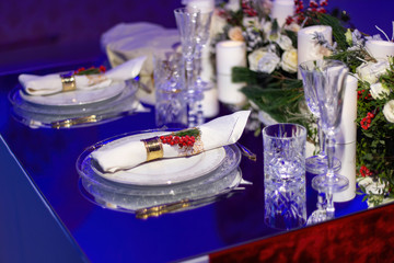 A festive table laid for Christmas. Mirror coating on the table.