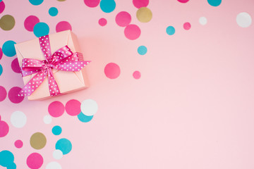 Decorated boxes and confetti on the pink background.