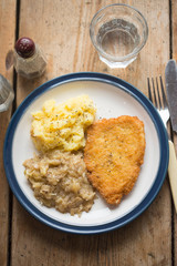 Breaded chicken breast with mashed potatoes and cabbage 