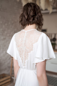 Young lady with in elegant white standing on room