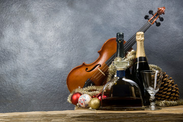 New Year's card with violin and bottles of champagne and liquor