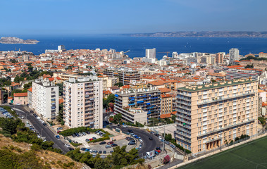 Fototapeta premium Marseille, France. Aerial panoramic view of the city, the bay and islands from the top of the hill in a summer sunny day. Holidays in France.