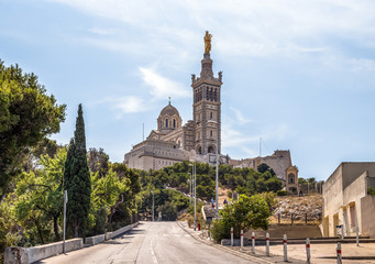 Basilica of Notre Dame de la Garde in Marseille, France, landmark of the city. Empty road leading...
