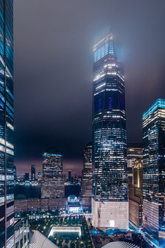 Manhattan skyscrapers at night reach the clouds