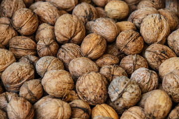 walnuts, unpeeled greek nuts, harvest of walnuts, walnuts closeup, background with walnuts,organic delicious nuts. healthy snack.