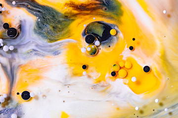 Alcohol ink mixing raster background. White fluid with black and yellow color bubbles illustration. Abstract contemporary art. Acrylic, oil paint flow with blue sparkling glitter backdrop.