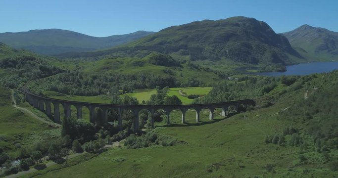Wide aerial of Glen Finnan Viaduct in the Scottish Highlands with Loch Shiel in the background on a sunny day