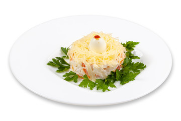 Salad with carrots, eggs, parsley and cheese in a white plate.
