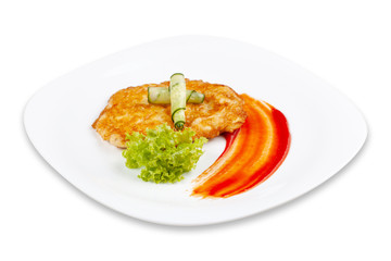 Chicken chop with cucumber and lettuce on a white plate